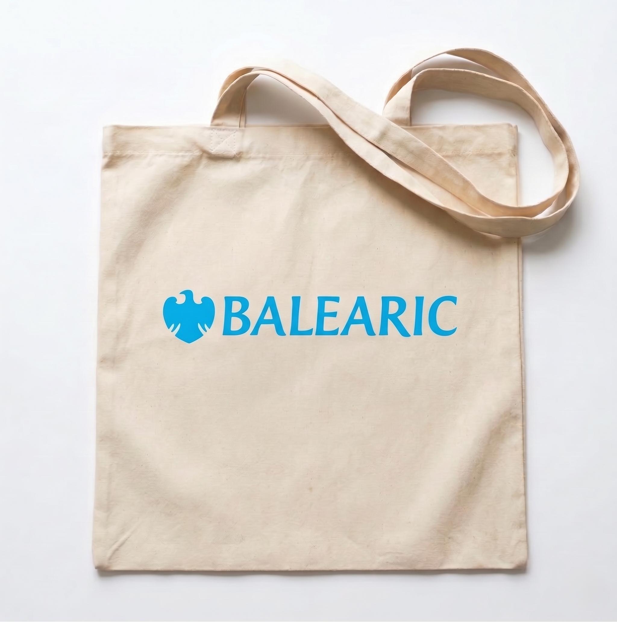 Beige tote bag with 'BALEARIC' logo on a white background