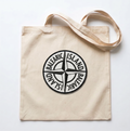 Beige tote bag with a black compass design on a white background